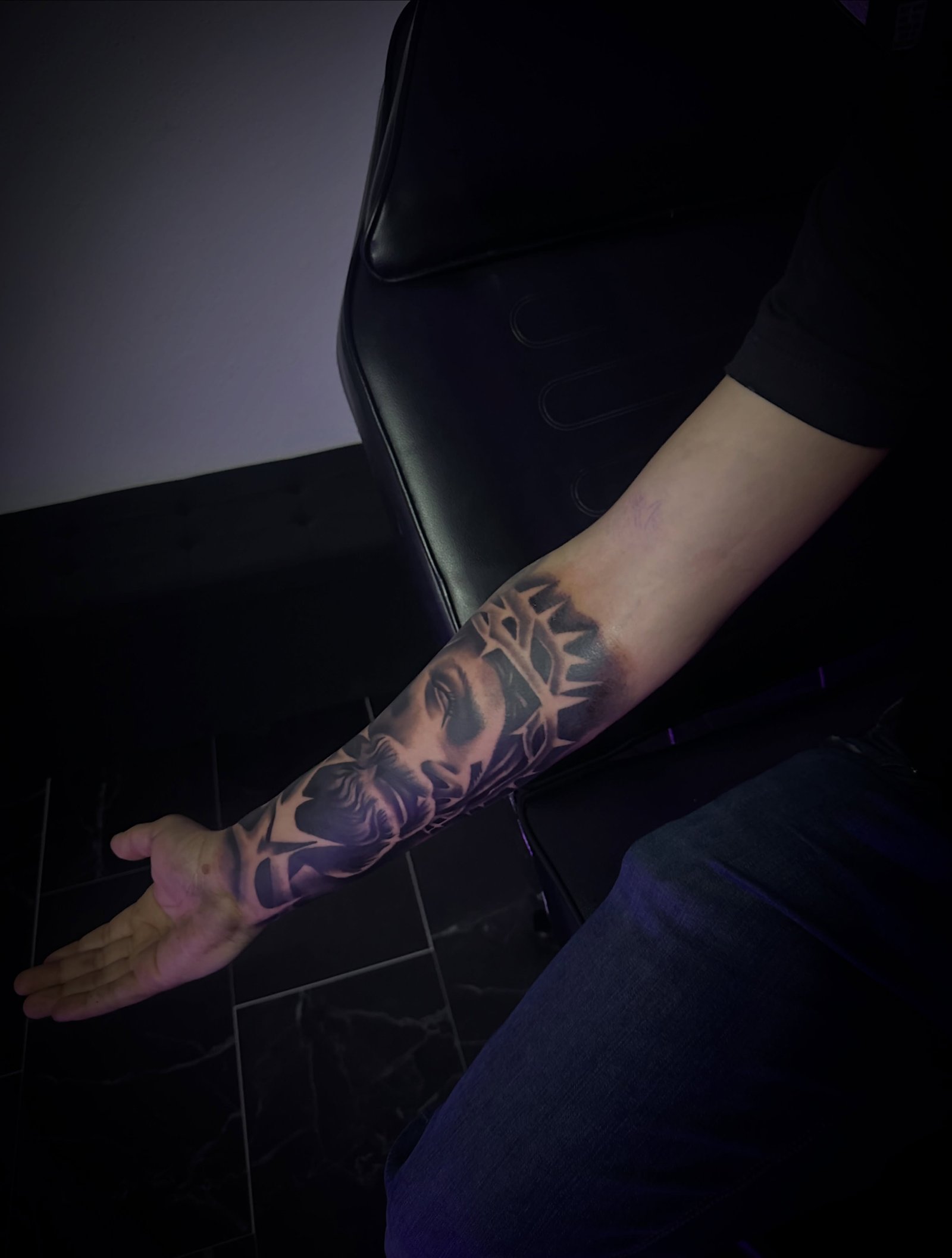 Realism portrait forearm tattoo